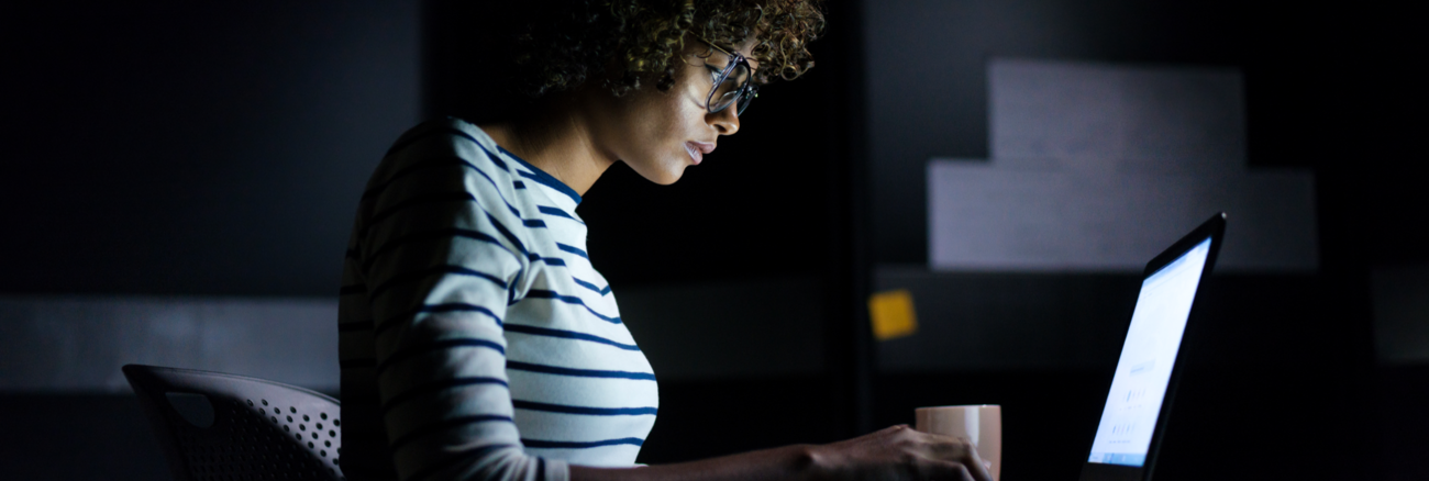 Eine Studentin arbeitet im Dunklen an einem Laptop-Computer © iStock/aldomurillo